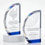 Blue crystal trophy with curved sail-shaped clear body and blue base