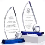 Engraved crystal trophy sail awards with globe accents and blue crystal bases