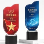 Red star flag and blue e-network crystal award designs on black cylindrical bases
