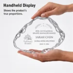 Handheld irregular iceberg crystal award showing scale
