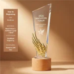 True to Beginning crystal award with gold wing motif and wood base 8 × 28 cm