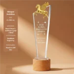 Winged Ambition crystal award with gold Pegasus and wood base 8 × 28.5 cm